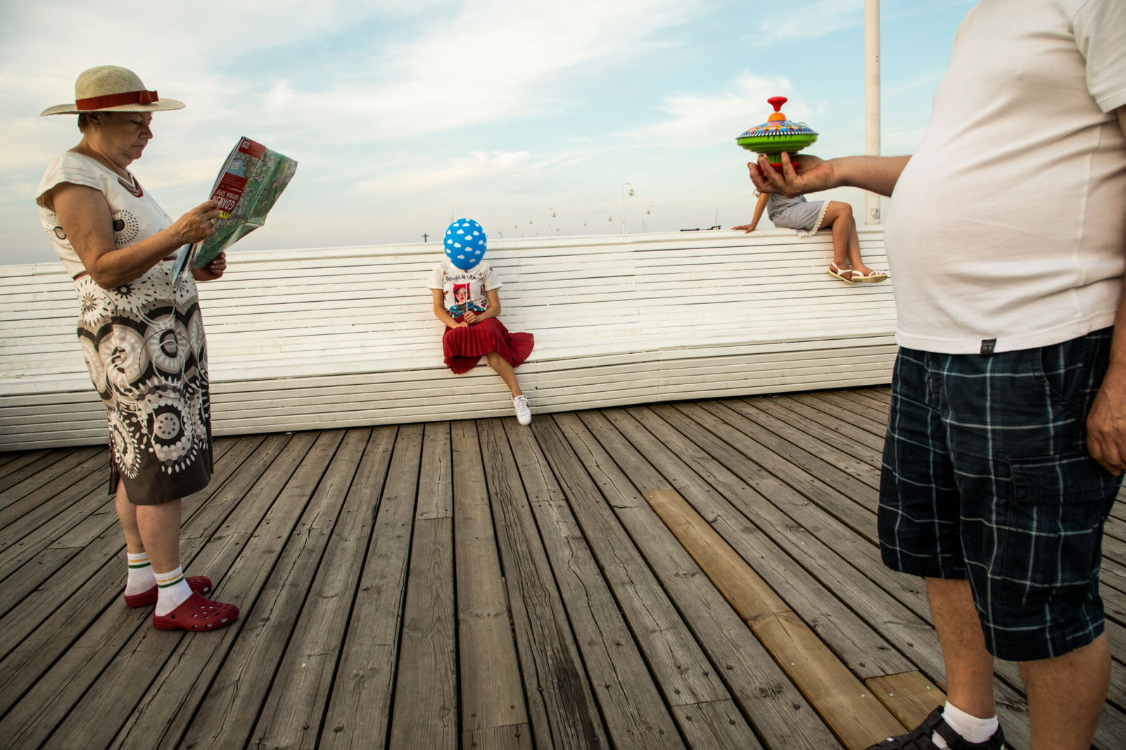 color street photo of people at pier in Sopot, Poland in summer, by Szymon Lewinski