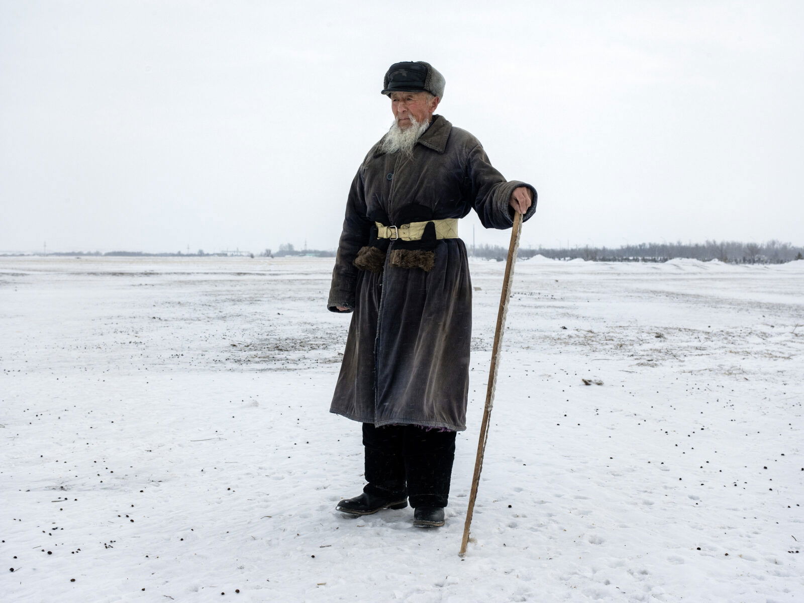 Documentary photography by Andrew McConnell. Portait of a shepherd in snow covered fields. Karaganda region, Kazakhstan 2020