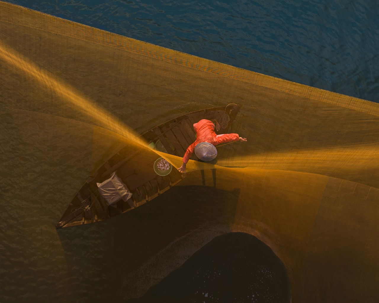 color photo of woman weaving in Hội An, Vietnam by Mahendra Bakle