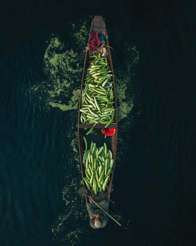 Color travel photography of vegetable seller on boat by Mahendra Bakle