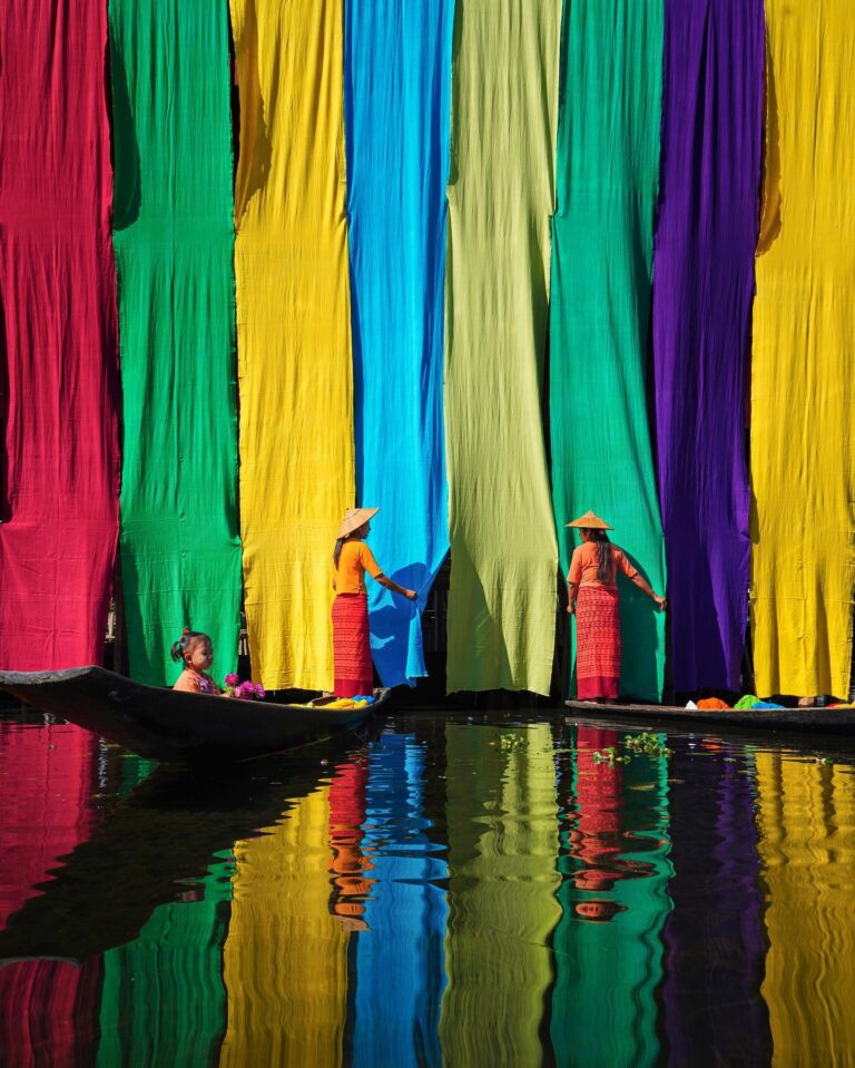 Color travel photography of womwen drying colorful fabric by Mahendra Bakle