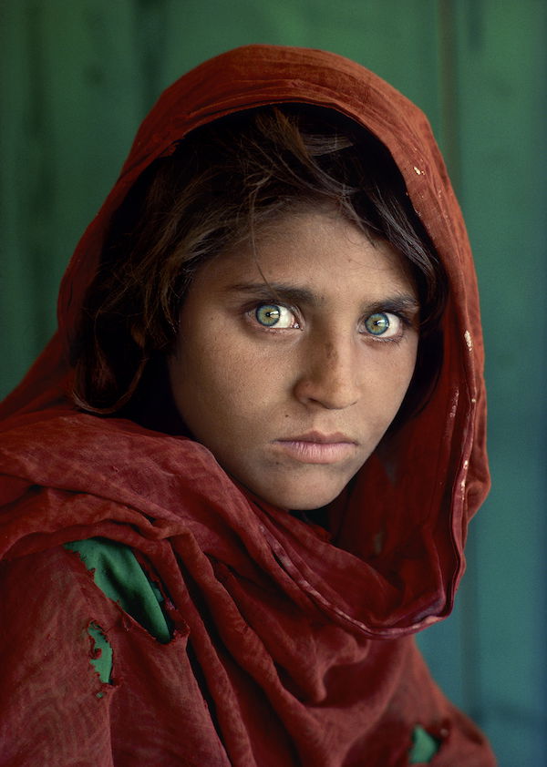 color photo of Sharbat Gula, Afghan Girl. Peshawar, Pakistan, 1984, by Steve McCurry