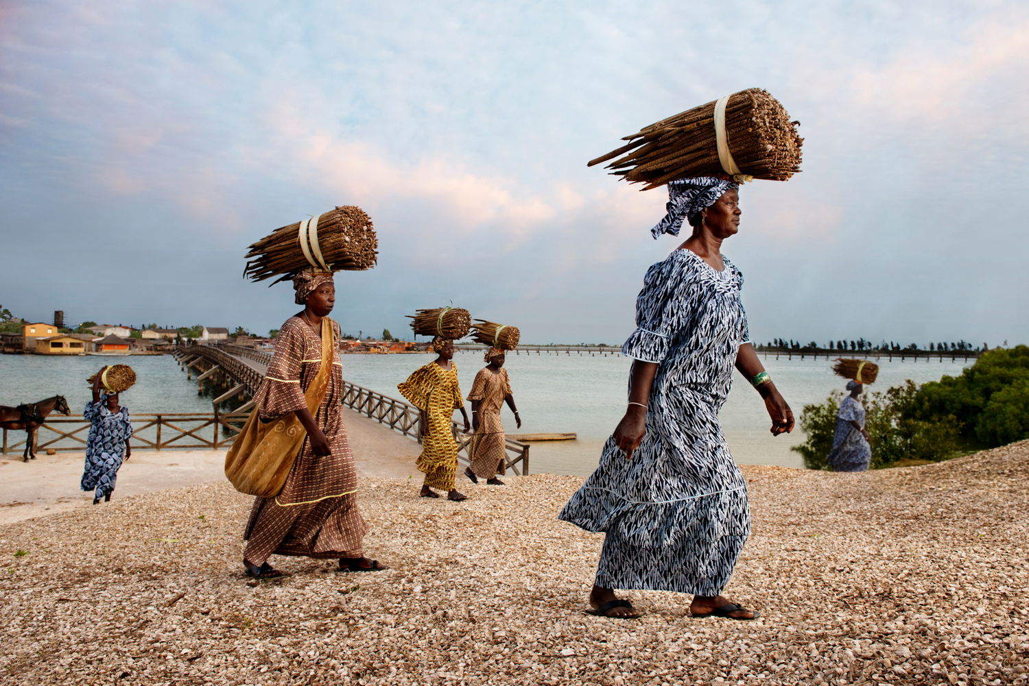 color photo of Women carring bundles on their heads, Tanzania, 2014 by Steve McCurry