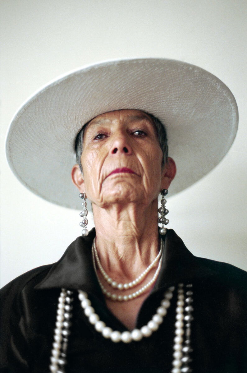 Portrait photo of an older woman in a hat by Marisol Mendez