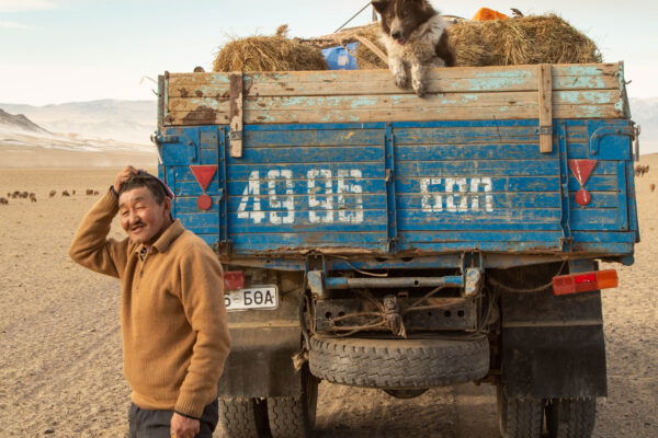 color portrait and travel photo of man, dog and truck in Western Mongolia by Alessandra Manzotti