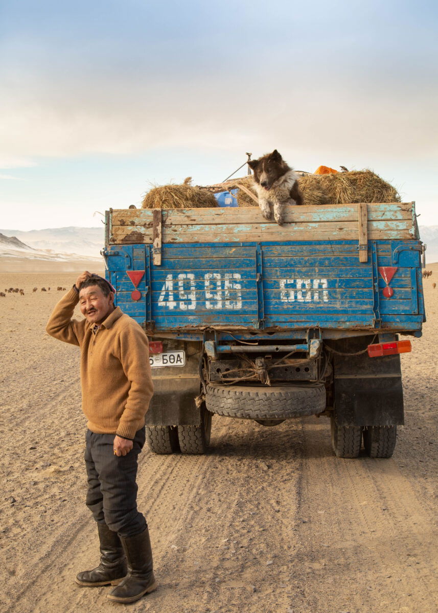 color portrait and travel photo of man, dog and truck in Western Mongolia by Alessandra Manzotti