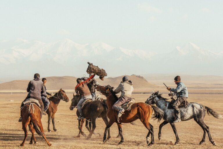 color landscape and travel photo of men playing on horses by Joe Buergi