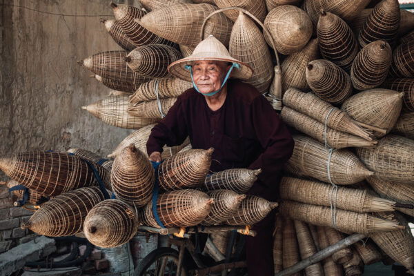 Color portrait photo of man on bicycle in Vietnam by Vincenzo Avallone