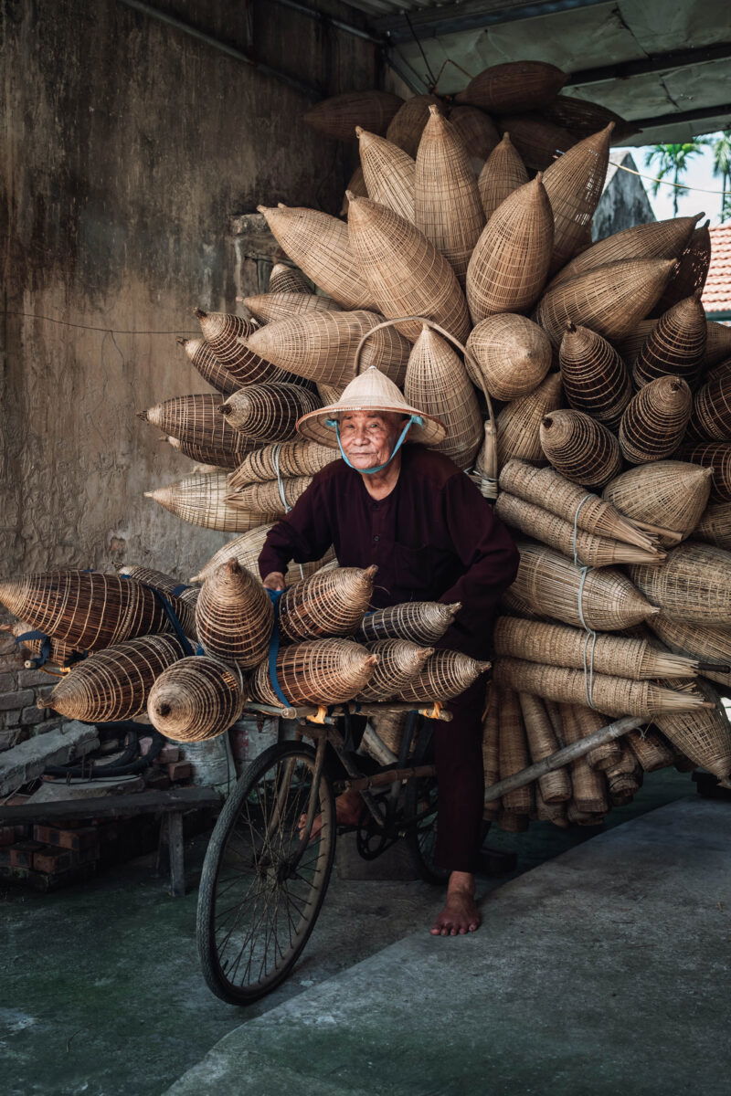 Color portrait photo of man on bicycle in Vietnam by Vincenzo Avallone