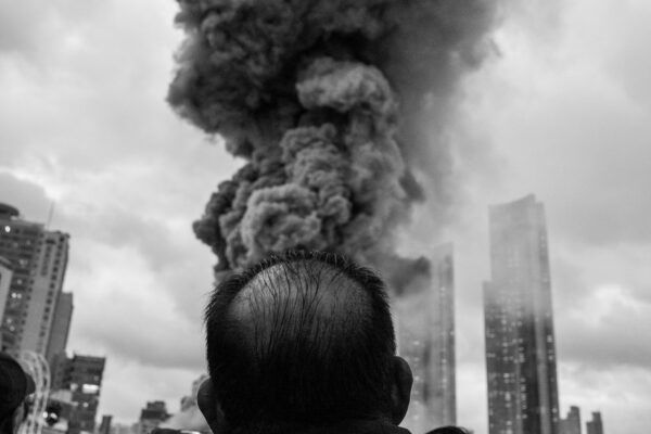 black and white street photo of man and smoke in South Korea by Jihhoon Kim